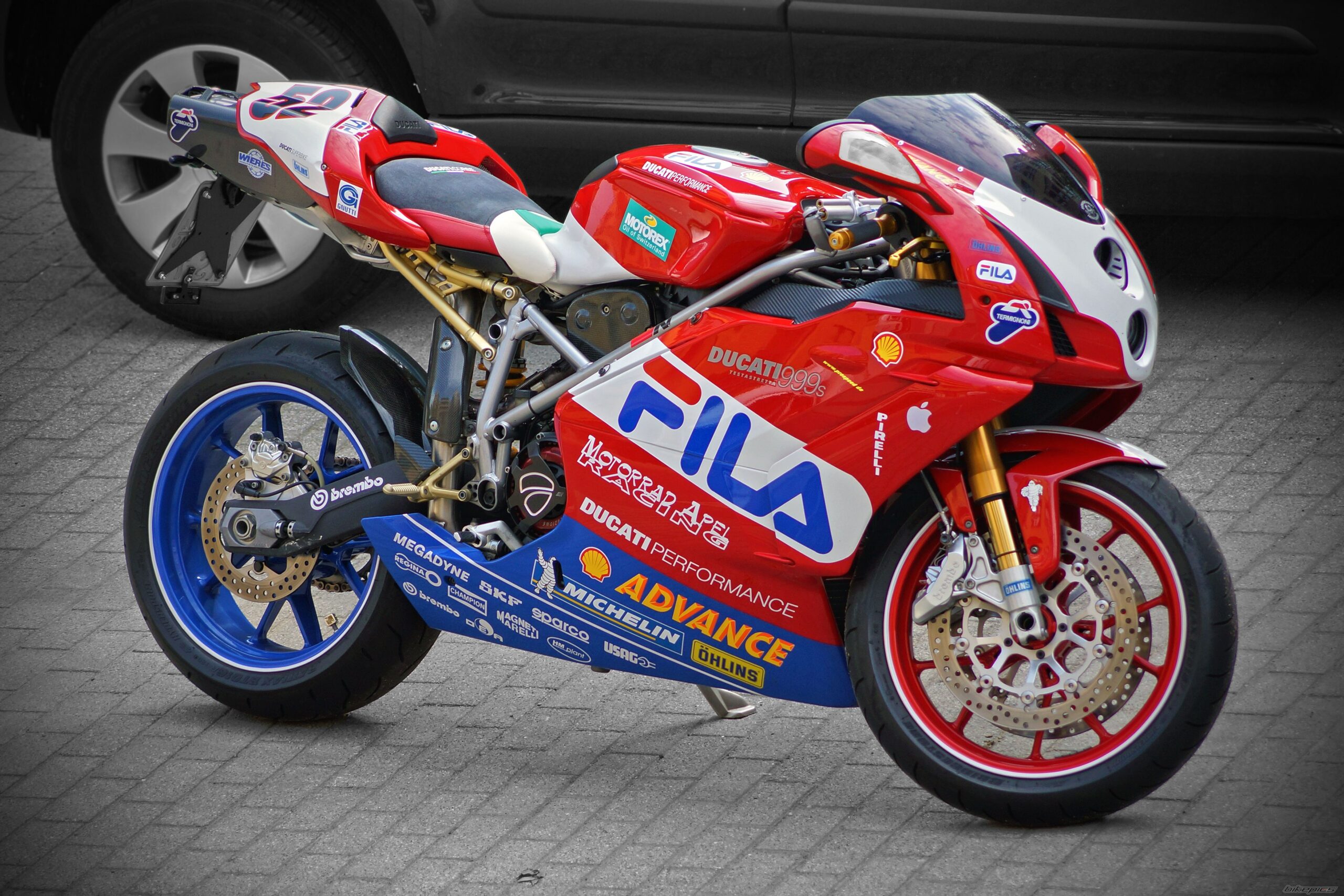 A image of Ducati 999r in red colour with multiple text on the bike