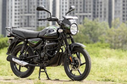 Bajaj CT 125X in black color near some greenry and big building