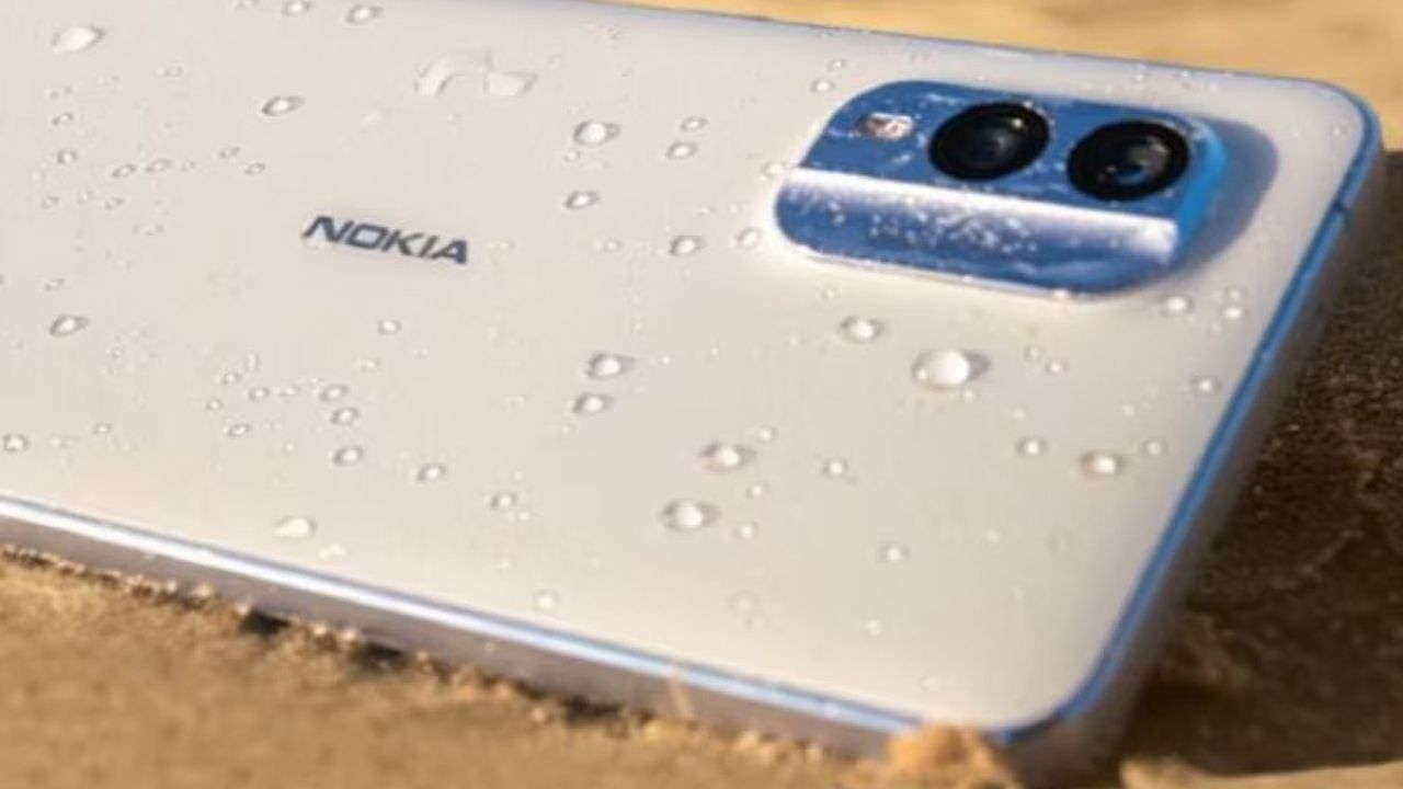 Nokia C12 Pro in beige color on sand and sparking some water on phone