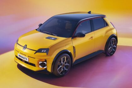 Renault 5 Electric Car in back and yellow color in yellowish and dark red background