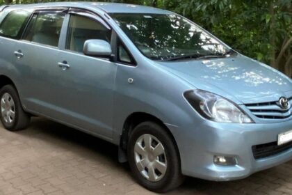 Toyota Innova in light blue color on road near some trees