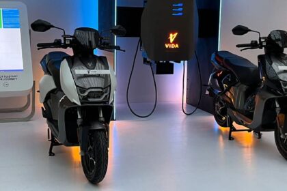 Here is image of Two electric scooter of Hero Vida V1 Which is in red colour and placed in Charging point