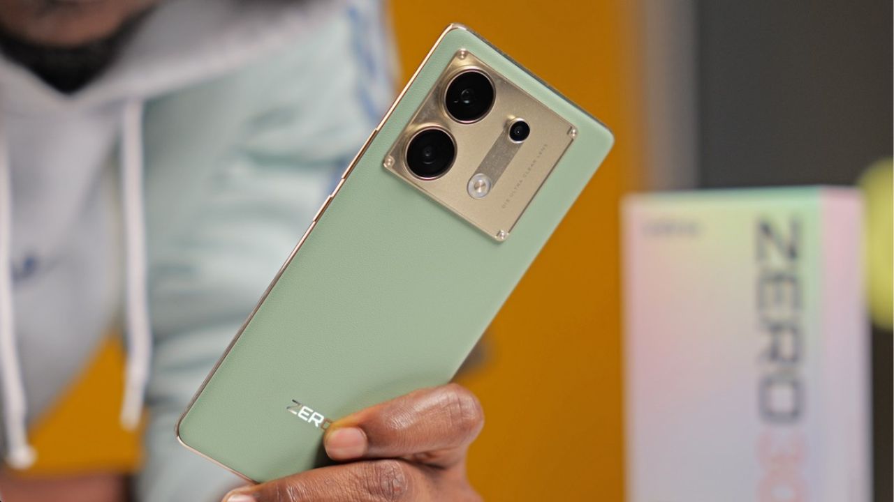 Infinix Zero 30 5G in mint green and gold color in a man hand with box near table