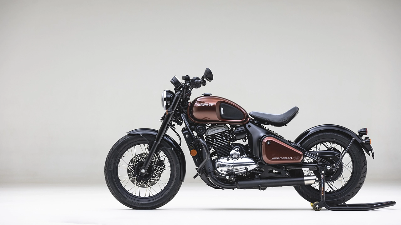 Here is Image of black and Dark brown colour Jawa 42 Bobber bike With plane White background