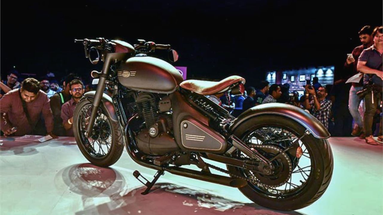 Here is image of Black Colour Jawa Perak Bobber Which is placed in showcase event where people taking pictures