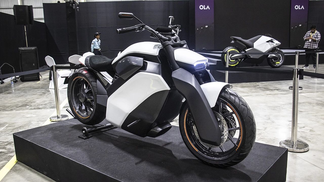 Here is image of Black and White colour OLA Cruiser electric bike Which is placed in showcase