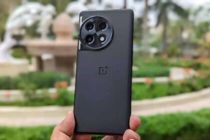 Oneplus 11R in black color infront of blurry park background
