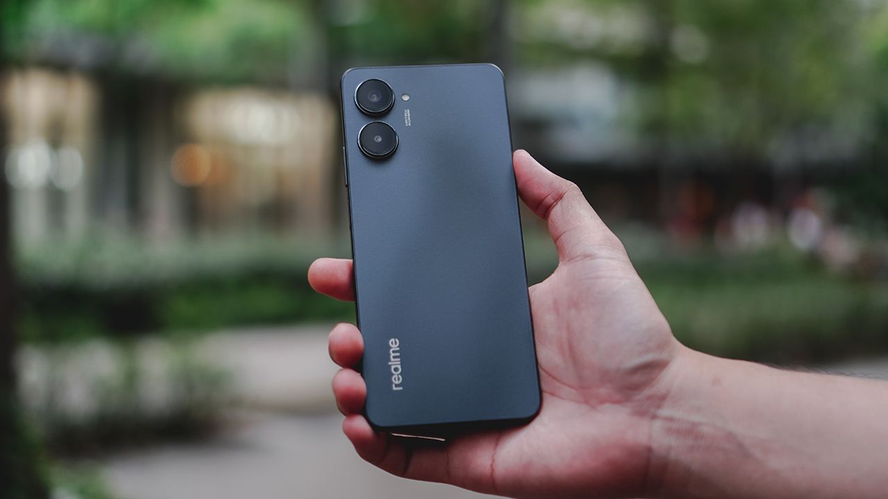 Realme 10 Pro 5G in black color in hand infront of bluryy background