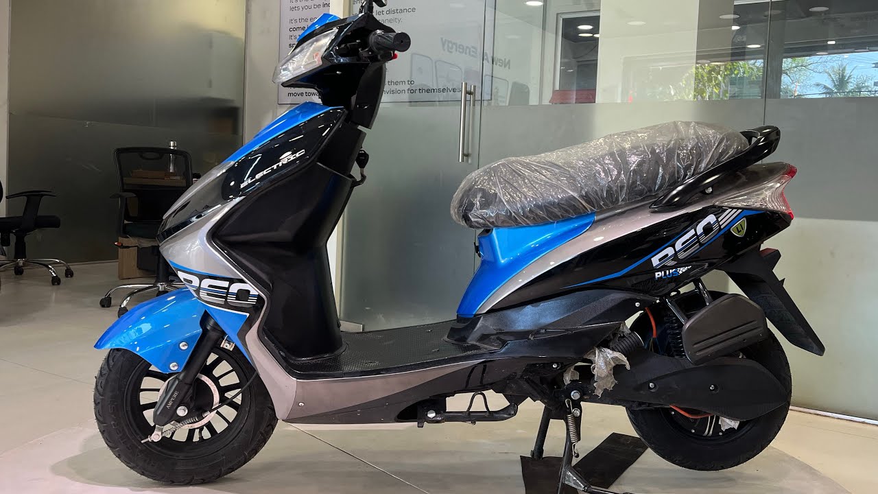 Here is image of black and blue colour Reo Li Plus Electric Scooter Which is placed in showroom