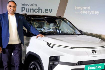 Here is Image of A man Standing with TATA Punch EV which is in white colour