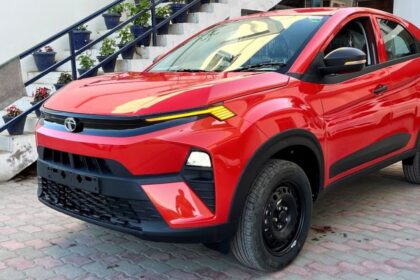 Here is image of red colour Tata Nexon suv Which is placed outside the house in front of Stairs
