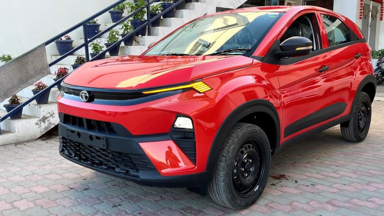 Here is image of red colour Tata Nexon suv Which is placed outside the house in front of Stairs