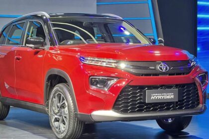 Here is image of Red colour Toyota Hyryder suv car which is placed in Showcase event
