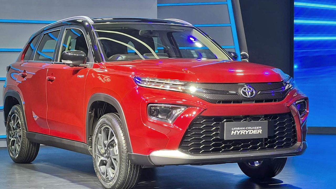 Here is image of Red colour Toyota Hyryder suv car which is placed in Showcase event