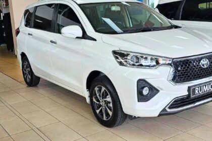 Here is image of White colour Toyota Rumion car which is placed in showroom