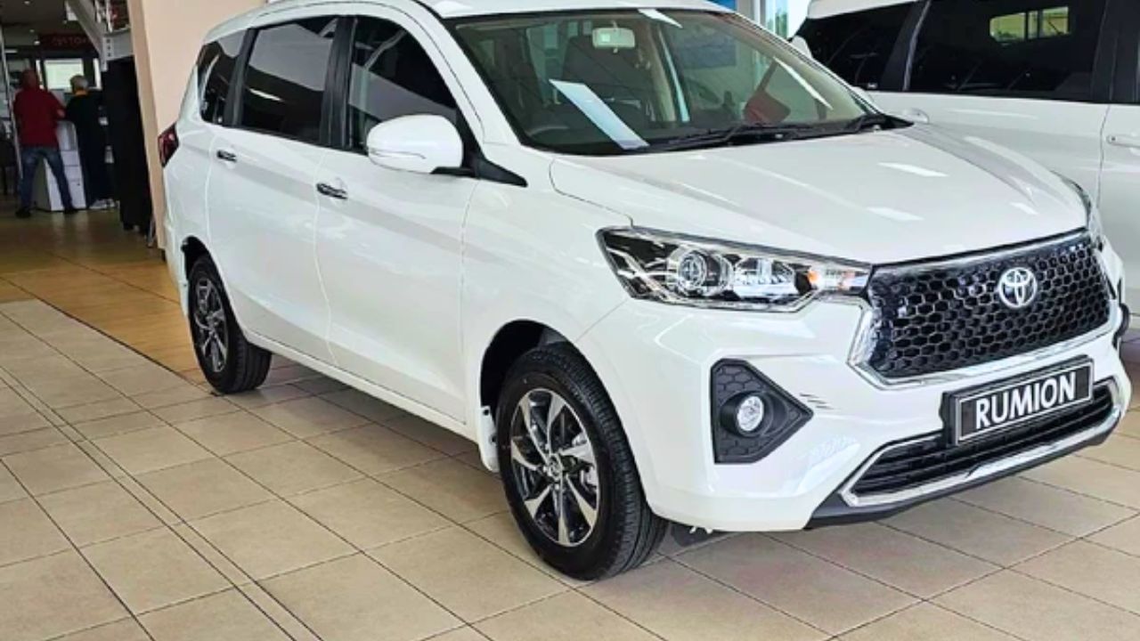 Here is image of White colour Toyota Rumion car which is placed in showroom